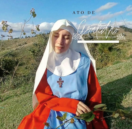 Irma Greice Maria sitting  in a field